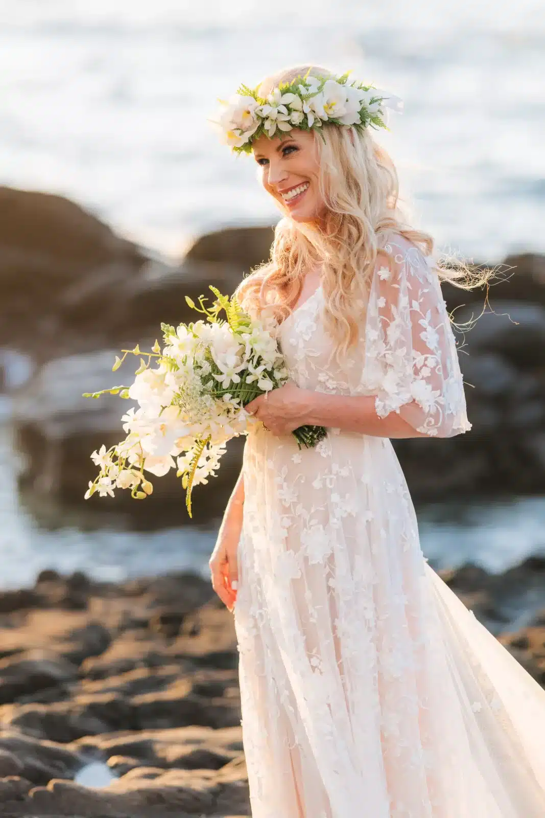 Bride holding her white tropical bouquet after her Big Island beach wedding