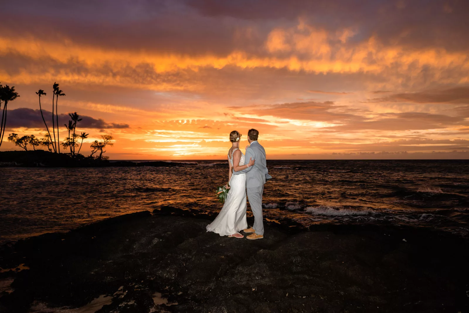 Stunning sunset skies for couple on lava after Big Island elopement