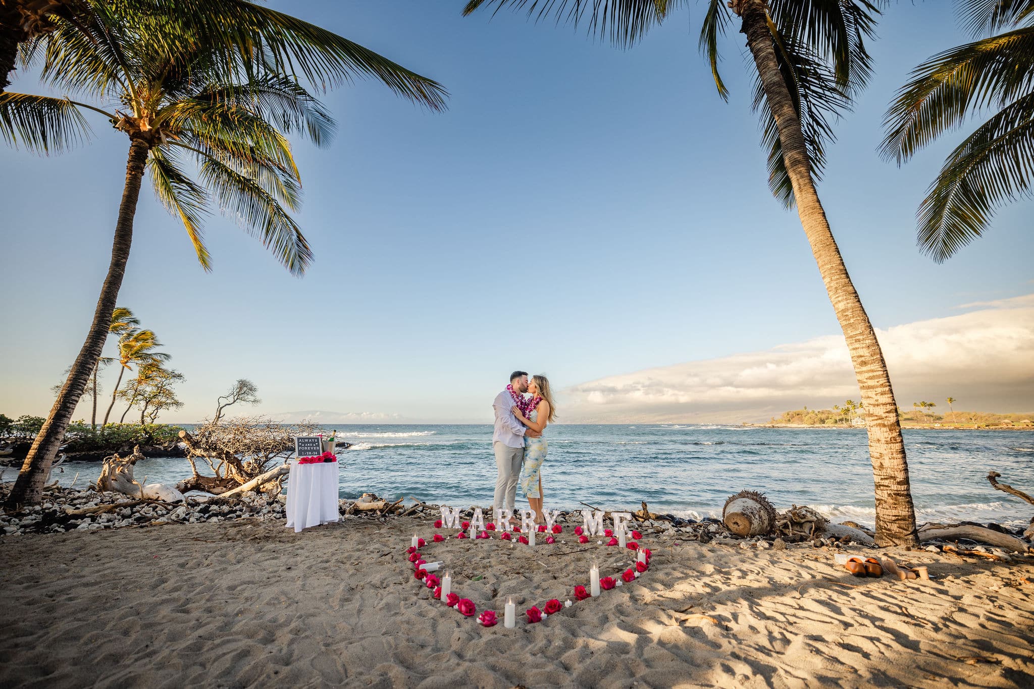 Couple with heart circle engaged in Hawaii on the beach